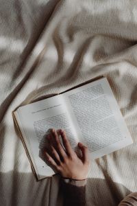 Kaboompics - Hands Turning Pages of an Open Book