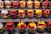 Kaboompics - Rows of Fresh Fruit Salad Cups at Barcelona's La Boqueria