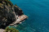 Kaboompics - Sun Loungers on a Rock Platform Above Turquoise Amalfi Coast Water
