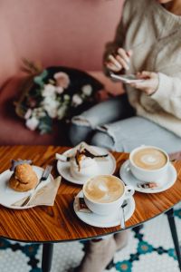 Kaboompics - A woman is using a phone in a café
