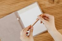 Kaboompics - Gold Pen Writing on Open Notebook Page