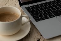 Kaboompics - Close Up of Coffee Cup Beside Laptop Keyboard