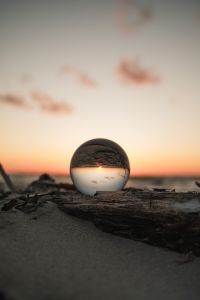Sunset Reflections on the Sea with Beach Waves and Coastal Light