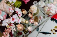 Kaboompics - Overhead Easter Table Flat Lay with Spring Branches, Pastel Eggs and Pink Floral Fabric