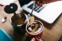 Kaboompics - Woman pours sugar into coffee