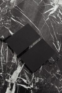 Kaboompics - Two Diagonal Black Business Cards on Black Marble, Vertical Branding Mockup