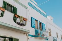 Kaboompics - White Mediterranean Facade with Blue Shutters and Flower Boxes