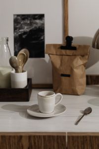 Kaboompics - Coffee Cup and Paper Coffee Bag on a Marble Countertop