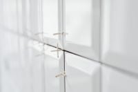 Kaboompics - Laying white ceramic tiles in the bathroom