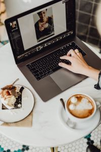 Kaboompics - Working with a laptop, meringue with whipped cream and coffee on white marble