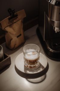 Kaboompics - Kraft Coffee Bag with Black Clip Beside Espresso Machine, Moody Home Coffee Bar Still Life