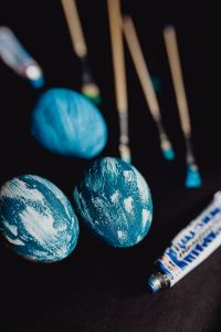Kaboompics - Woman Painting Blue Easter Eggs