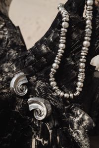 Kaboompics - Silver Earrings and Beaded Necklace on Driftwood