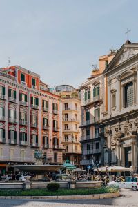 Kaboompics - Colorful Naples Piazza With Historic Church Facade and Outdoor Cafes