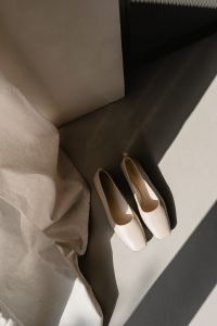 Kaboompics - White Pointed Shoes by Linen Curtain