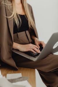 Kaboompics - Close-Up of Businesswoman Writing on Laptop at Work