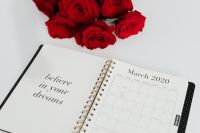 Kaboompics - Top-Down March Planner and Red Rose Bouquet, Motivational Home Office Flat Lay
