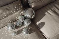 Kaboompics - Party Light Reflections Across a Close Cluster of Disco Balls on Sofa