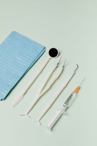 Kaboompics - Dental Tools on Blue Disposable Bib, Portrait Flat Lay