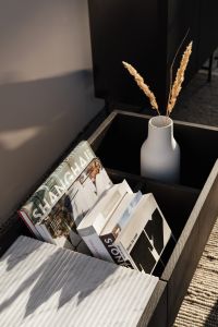 Kaboompics - Coffee Table Books and Dried Pampas in a Ceramic Vase on a Dark Console