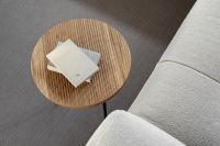 Kaboompics - Round Fluted Oak Side Table with Books Beside Beige Sofa