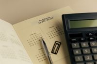 Kaboompics - 2027 Yearly Overview With Calculator Pen and Office Supplies