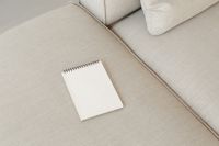 Kaboompics - Spiral Sketchbook Mockup on a Textured Beige Sofa