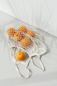Kaboompics - Top-Down Eco Grocery Flat Lay with Mesh Produce Bags and Fresh Oranges
