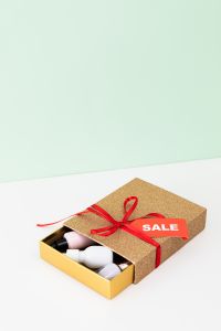 Kaboompics - Open Gold Gift Box with Beauty Products, Sale Tag and Copy Space