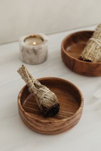 Kaboompics - Close-Up Sage Bundle In Wooden Bowl With Candle