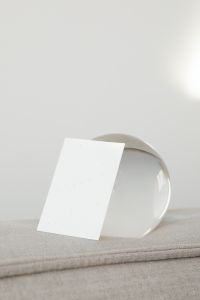 Kaboompics - Vertical Card Mockup in Front of Clear Glass Orbs