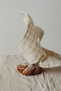 Kaboompics - Linen Tea Towel Draped Over Artisan Bread