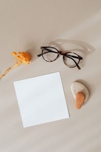 Kaboompics - Blank Branding Card with Eyeglasses, Stones and Dried Flower