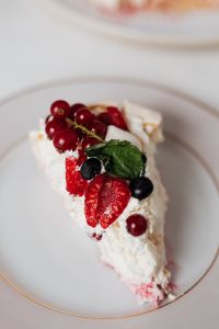 Kaboompics - Close-Up Pavlova Slice with Red Currants and Fresh Raspberries