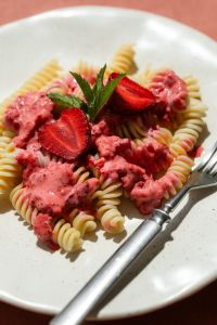Kaboompics - Strawberry Fusilli With Fork on a Coral Tablecloth
