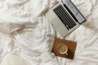 Kaboompics - Laptop and Coffee on White Bed, Minimal Work From Home Copy Space