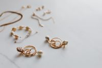 Kaboompics - Gold jewellery on white marble - necklace, bracelets, earrings
