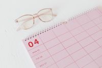 Kaboompics - Pink April Desk Calendar with Rose-Tinted Glasses for Productivity Planning