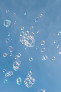 Kaboompics - Iridescent Soap Bubble Pattern on a Soft Blue Background