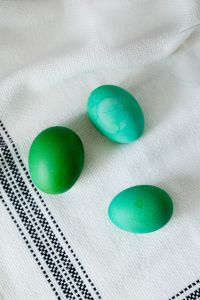 Kaboompics - Two Green and Turquoise Easter Eggs on White Fabric
