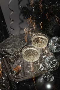 Kaboompics - Champagne Coupes and Silver Disco Balls on a Reflective Party Tray