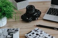 Kaboompics - Black-and-white photos with a silver laptop, pencils and a camera