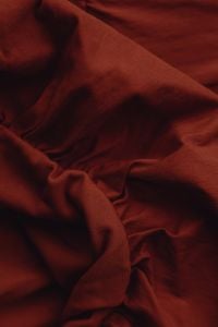Kaboompics - Rust Burgundy Fabric With Diagonal Folds