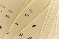 Kaboompics - Layered Calendar Pages With Sunday Dates Close Up