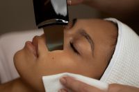 Kaboompics - Skincare Device Applied to Cheek with Cotton Pad
