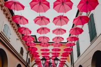 Kaboompics - Pink Umbrella Installation Between Designer Outlet Buildings