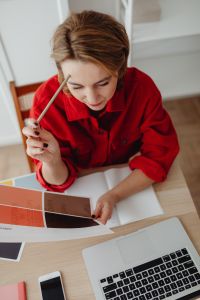 Kaboompics - Top View of Woman Writing with Laptop, Phone and Color Swatches