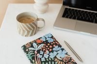 Kaboompics - Colorful Floral Journal and Laptop with a Coffee Break Setup