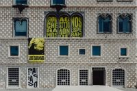 Kaboompics - Geometric Tiled Lisbon Facade with Cultural Posters and Arched Doorways