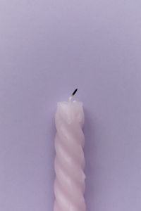 Kaboompics - Single Twisted Candle On Purple Background